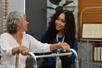 Young CNA helping Senior in Walker