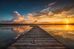 Dock on lake at sunset