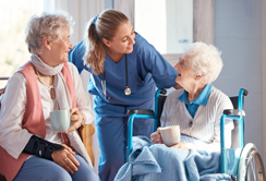 Nursing Assistant with two elderly patients in Skilled Nursing Facility